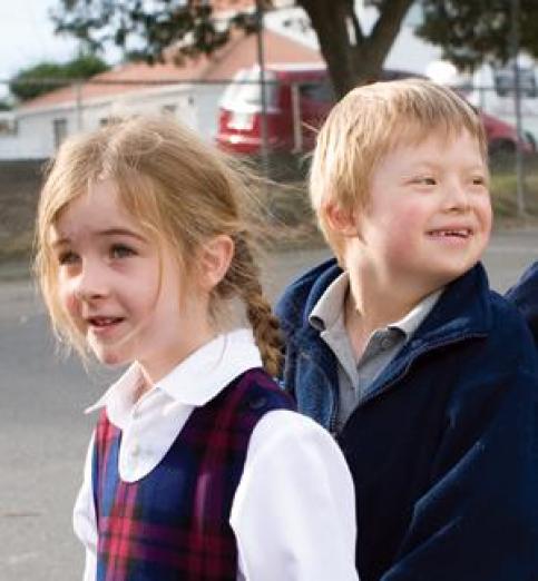 Two primary age children lining up in the playground